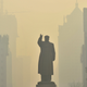 A statue of China’s late Chairman Mao Zedong is seen in front of buildings during a hazy day in Shenyang, Liaoning province, on May 7, 2013.
